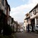 A narrow cobblestone lane lined with half timber buildings and old shops
